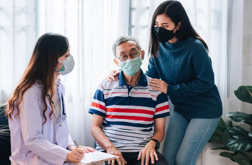 Healthcare professional discussing care plan with elderly patient and family member, emphasizing compassion and support in hospice care.